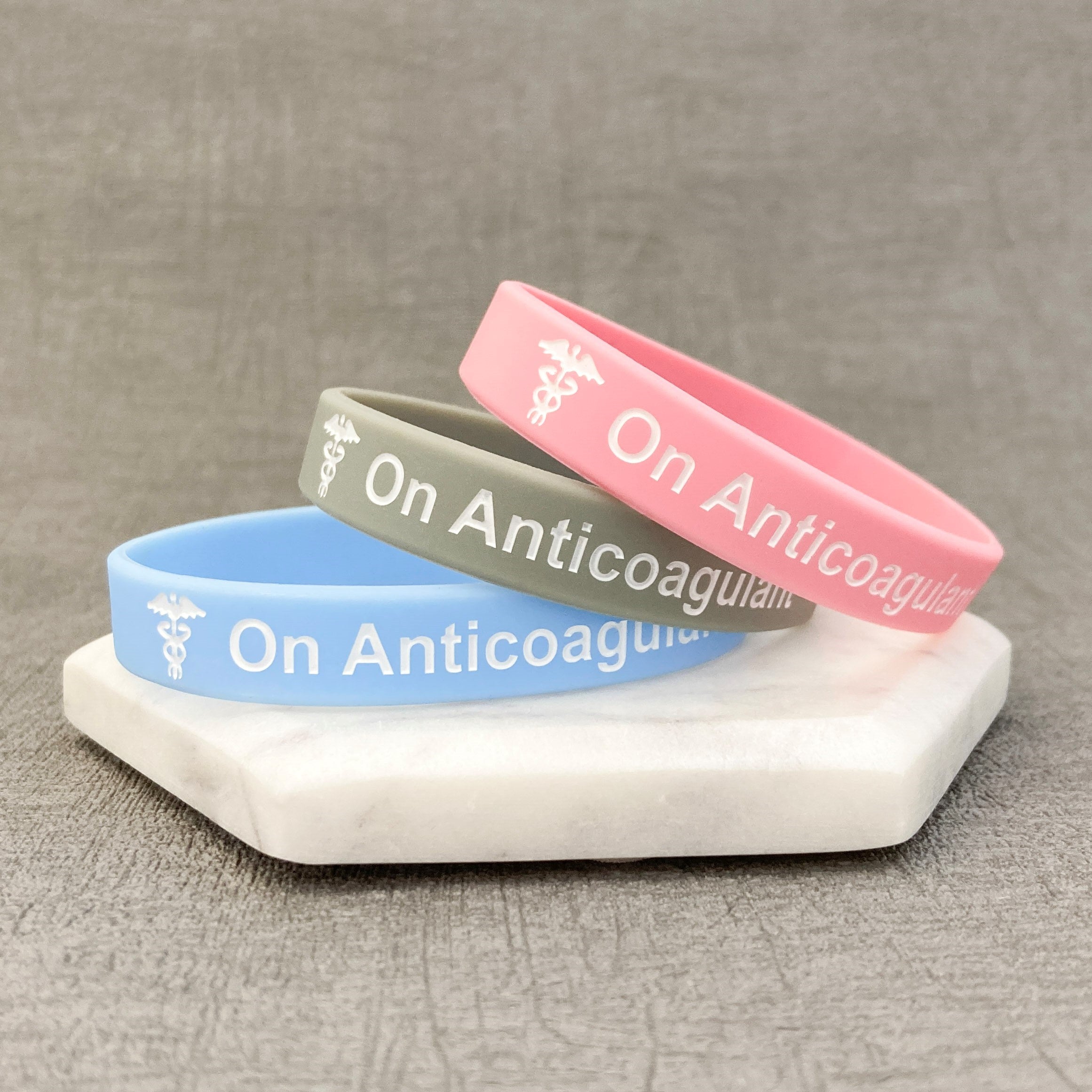 anticoagulant-awareness-bands-pink-grey-sky