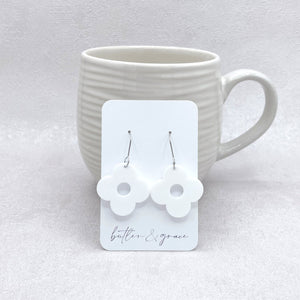 Butler & Grace earrings on a card with a white mug in the background