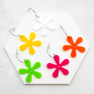 Hippie style flower earrings in multiple colours on a white surface