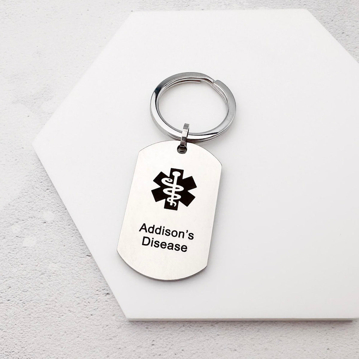 Medical alert keychain with 'Addison's Disease' text on a white background