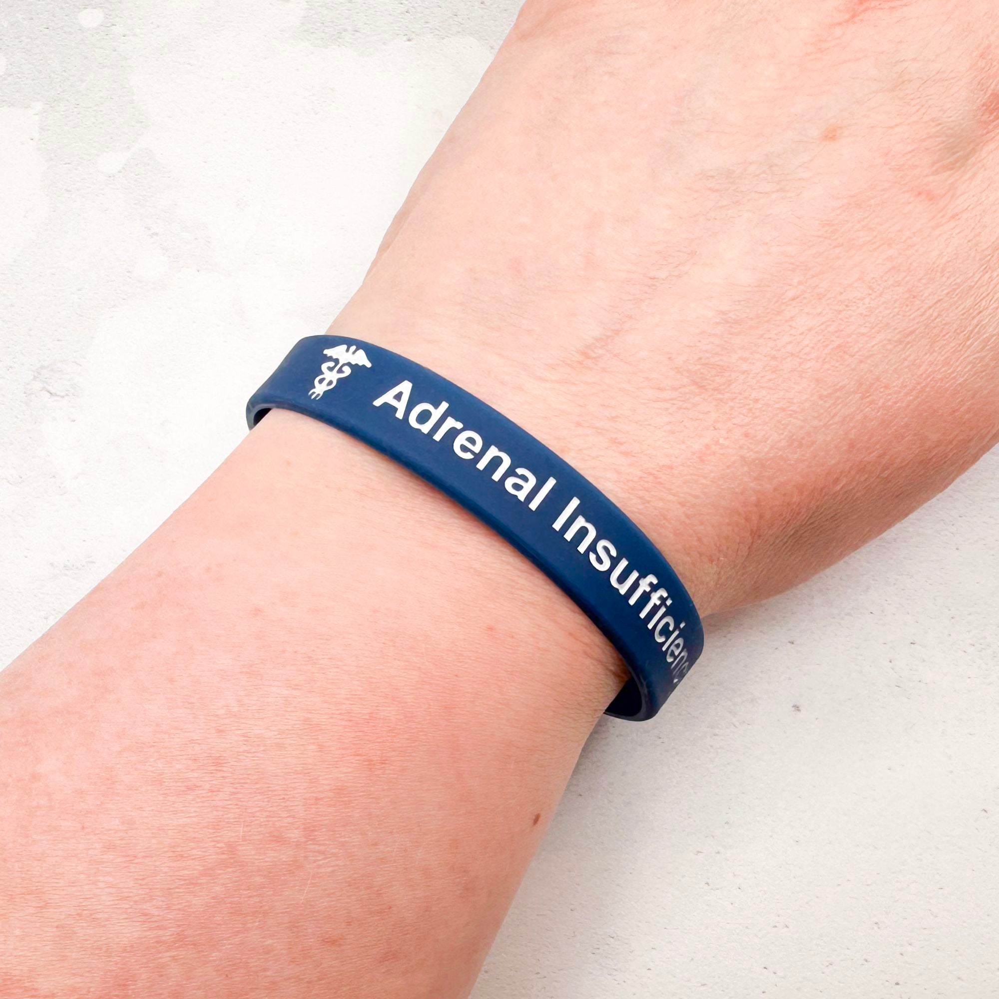 navy silicone adrenal insufficiency medical alert wristband worn on wrist