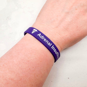 purple silicone adrenal insufficiency medical alert wristband worn on wrist