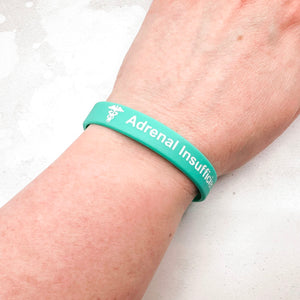 teal silicone adrenal insufficiency medical alert wristband worn on wrist