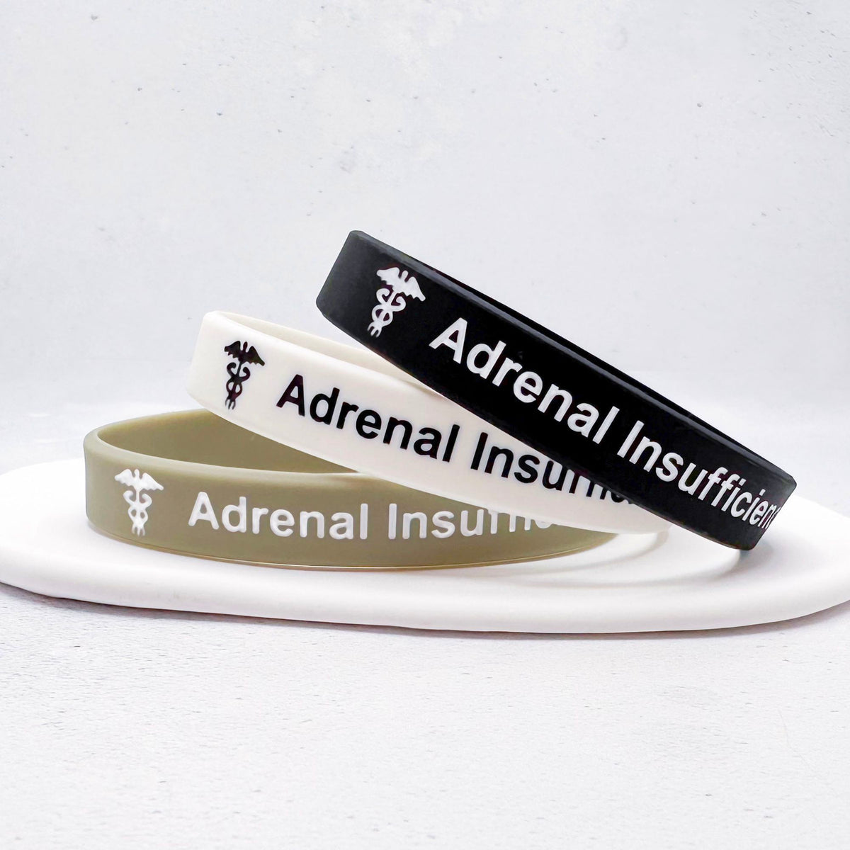 Set of three grey, white, and black silicone medical alert wristbands adrenal insufficiency