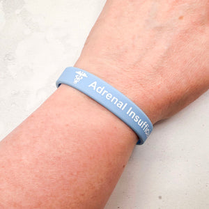 sky blue silicone adrenal insufficiency medical alert wristband worn on wrist