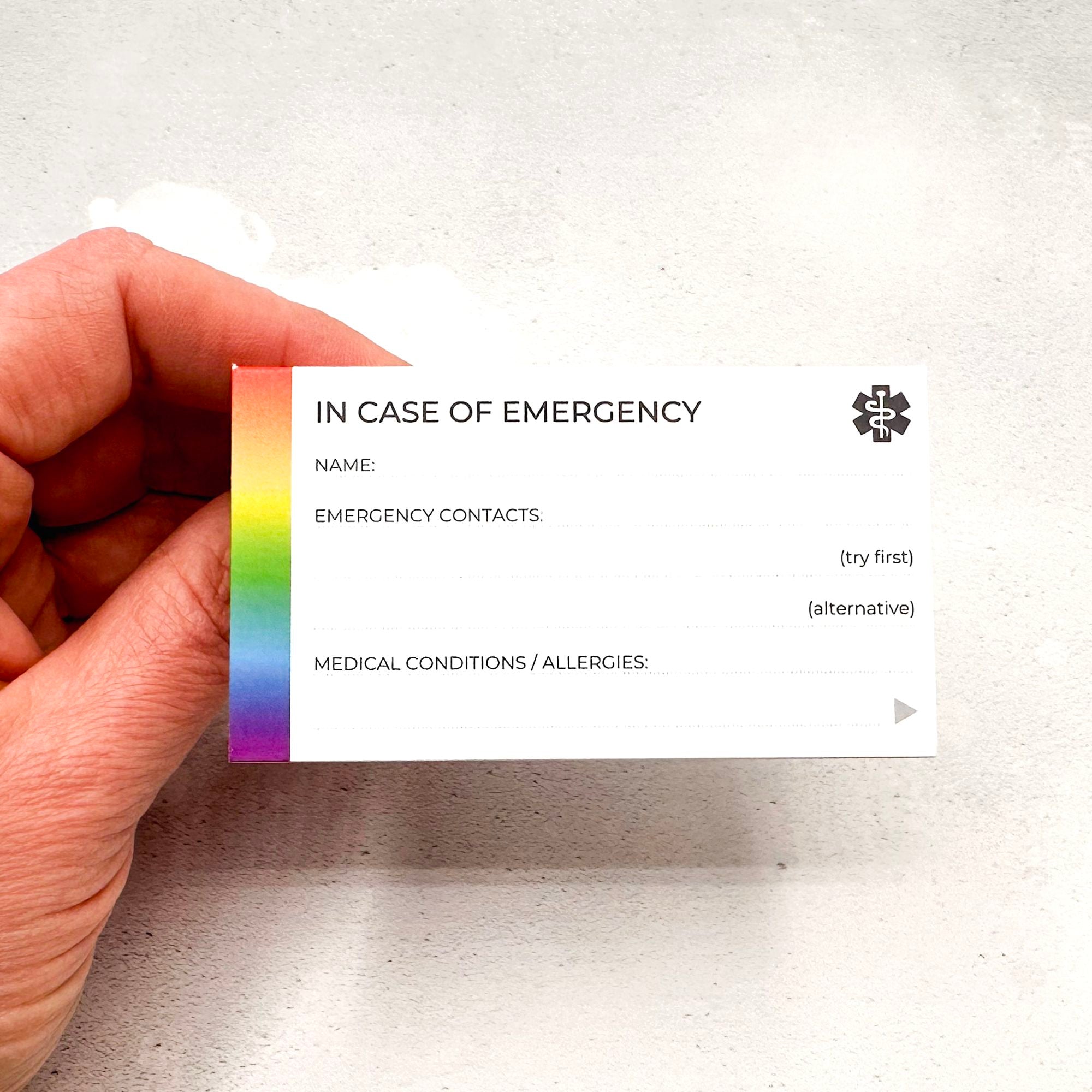 Front of autism wallet card with emergency contact fields and rainbow accent stripe