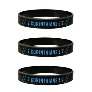 Three black wristbands with '2 Corinthians 5:7' printed in blue on a white background