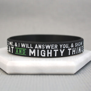 Black wristband with white text on a gray background