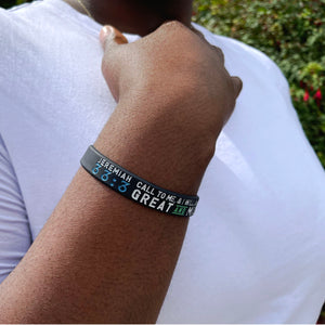black band with white and blue text worn on a wrist