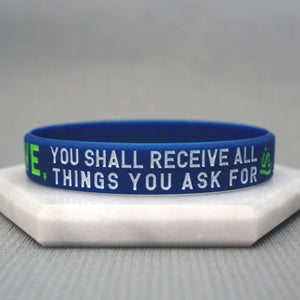 Blue wristband with text on a gray background