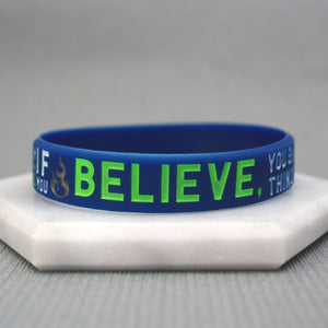 Blue wristband with green text on a gray background