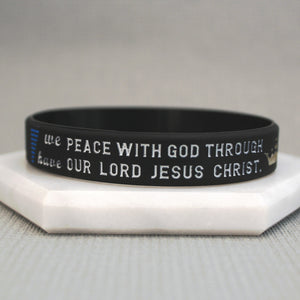 Black wristband with white text on a light gray background