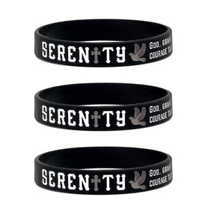 Three black silicone wristbands stacked vertically, each printed with the word 'SERENITY' in white and grey
