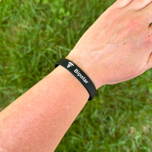 Person wearing a bipolar silicone medical bracelet on the wrist for everyday  safety