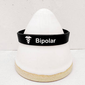 Close-up of a bipolar wristband showing clear medical identification text