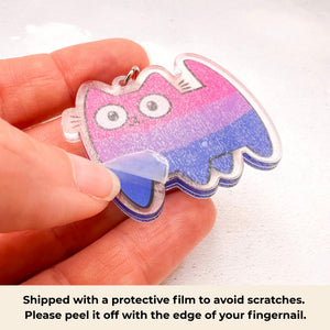 bisexual pride cat keychain shown with a protective film still attached