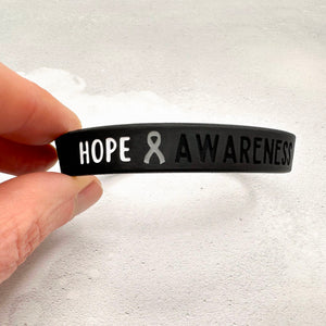 black silicone wristband engraved with ‘Hope & Awareness’ 