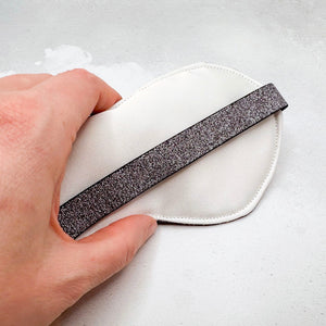 Hand holding a padded sleep mask