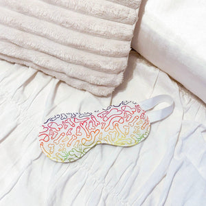 Eye mask with colourful male anatomy pattern on a bed