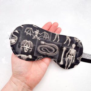 Sleep mask with x-ray animal design held in a hand