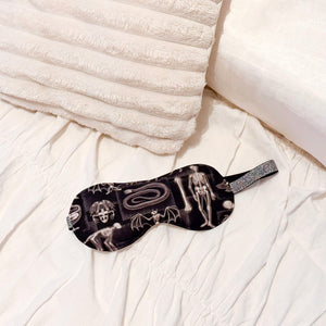 Sleep mask with x-ray animal design on a bed