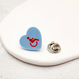 blue acrylic heart pin with disabled symbol in red