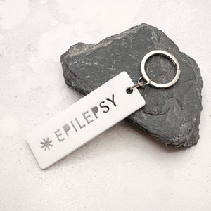 Lightweight epilepsy medical alert keychain showing laser cut design and durable acrylic material