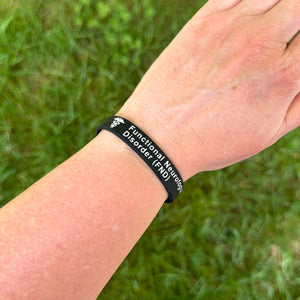 Person wearing a FND silicone medical bracelet on the wrist for everyday safety