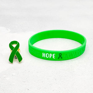 green awareness ribbon wristband with "hope & awareness" text engraved on the side and a matching green enamel ribbon pin besides it
