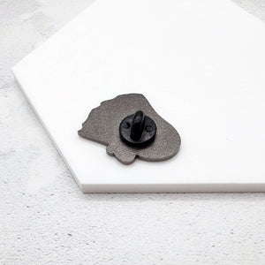 ghost pin face down with rubber backing on a white surface