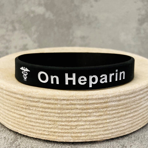 on heparin unisex wristband black white
