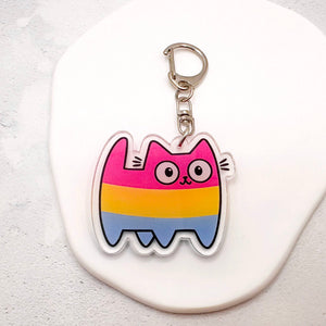 A pansexual-striped cat keychain charm with a silver metal clasp