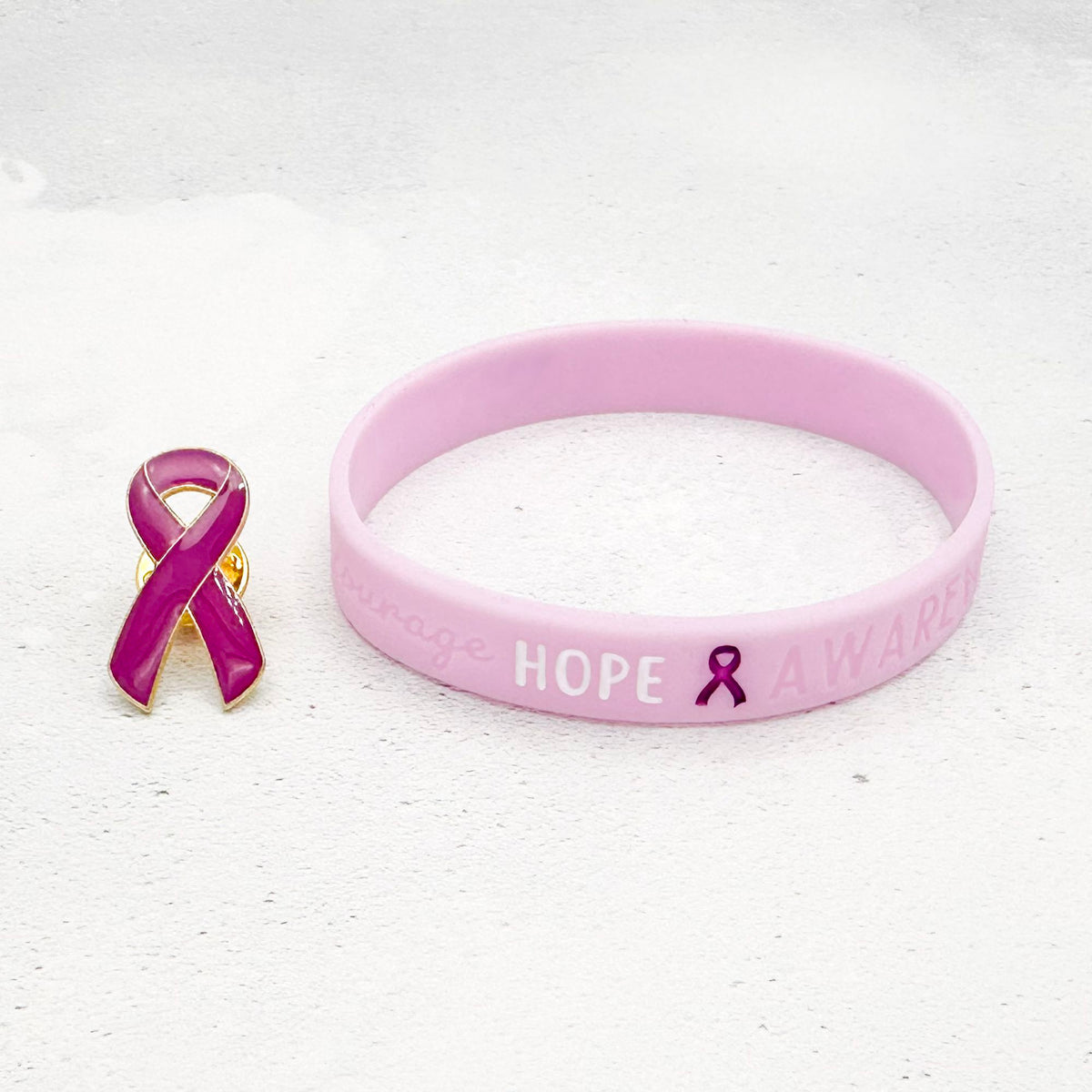 purple silicone wristband engraved with ‘Hope & Awareness’ besides matching purple enamel ribbon pin