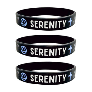 Three black silicone wristbands stacked vertically, each printed with the word 'SERENITY' in white, a light blue symbol, and a light blue cross.