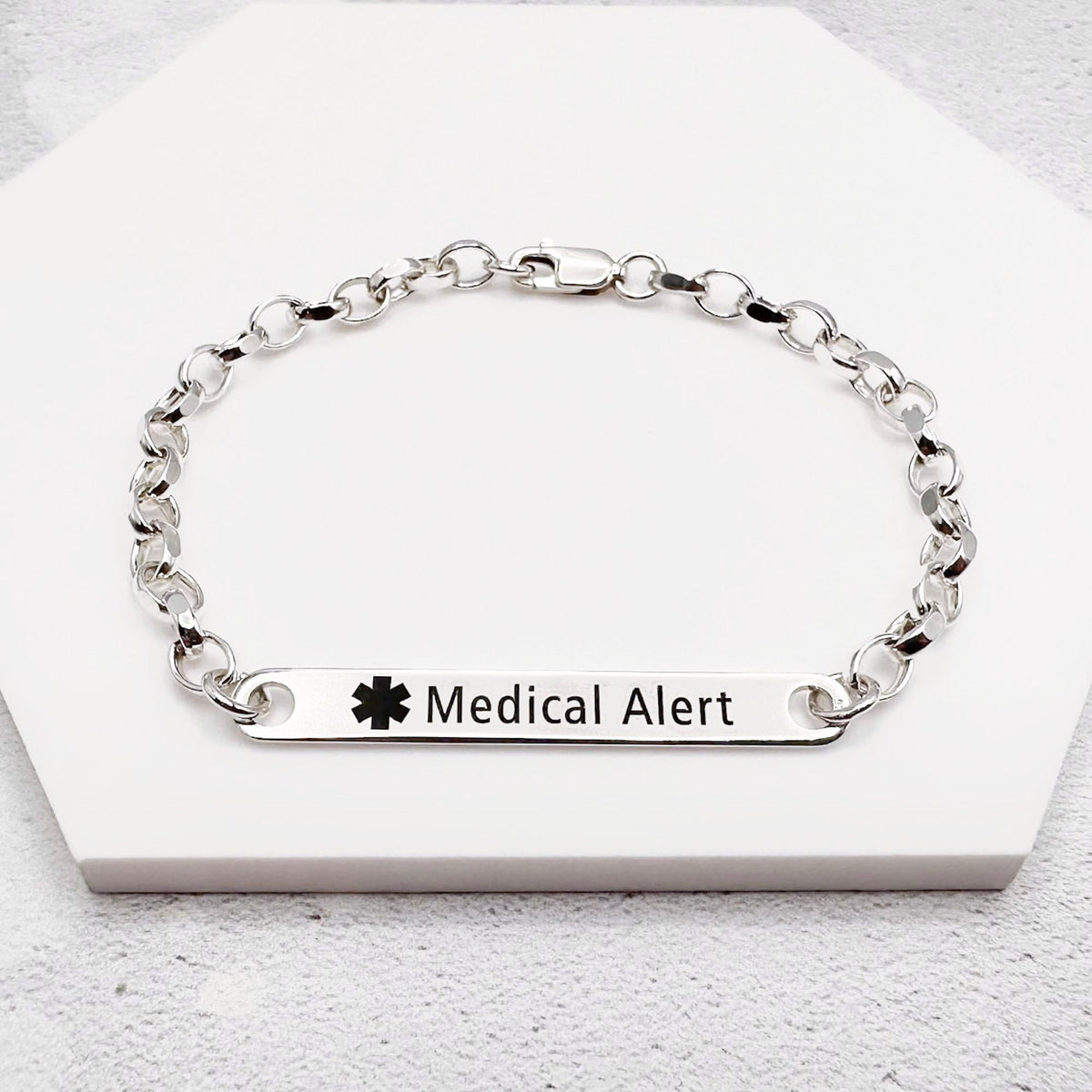 Silver medical alert bracelet on a white background