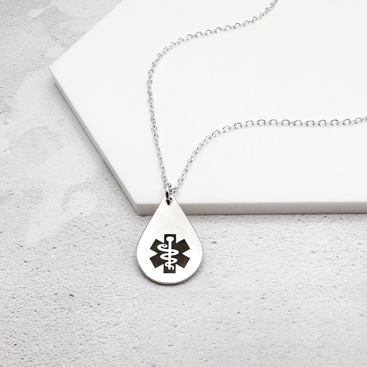 sterling silver medical alert necklace with star of life symbol on a teardrop-shaped pendant