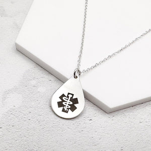 sterling silver medical alert necklace with star of life symbol on a teardrop-shaped pendant on a white surface