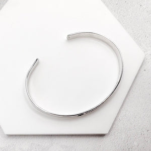 Silver cuff on a white surface