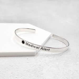 Silver medical alert bracelet on a white background