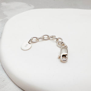 Sterling silver lobster clasp and chain extender with a round engraved tag