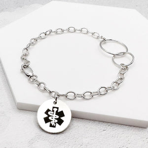 sterling silver chain bracelet with a round tag featuring the star of life medical symbol 
