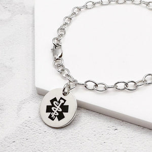 sterling silver bracelet with medical symbol on a light background