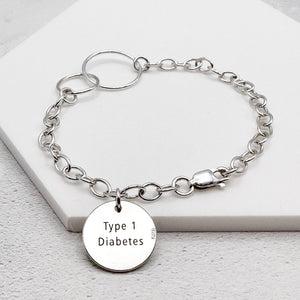 sterling silver chain bracelet with a round tag with "Type 1 Diabetes" engraved