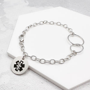 sterling silver chain bracelet with a round tag featuring the star of life medical symbol 