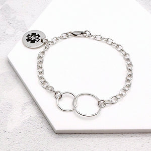 sterling silver chain bracelet with a round tag featuring the star of life medical symbol and interlocking rings
