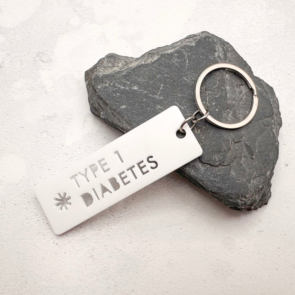 Lightweight T1D medical alert keychain showing laser cut design and durable acrylic material