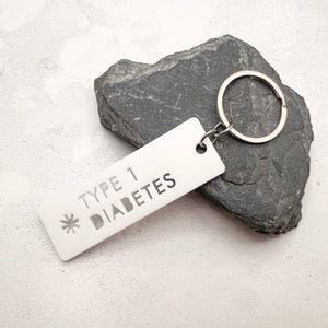 Lightweight T1D medical alert keychain showing laser cut design and durable acrylic material