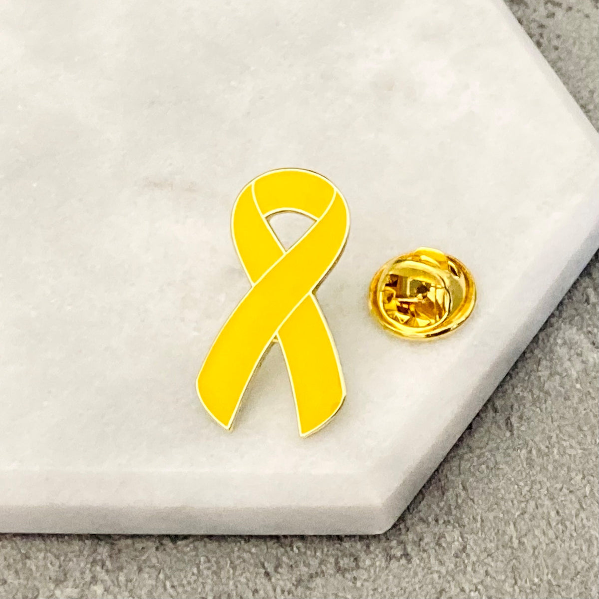 yellow awareness ribbon pin cancer support