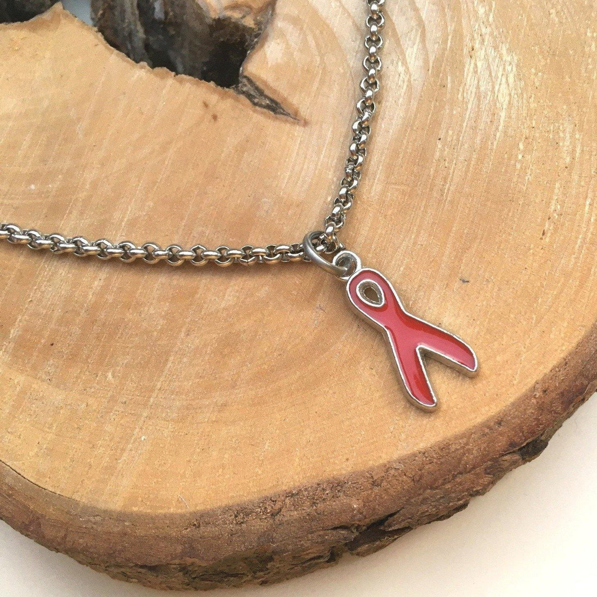 Red awareness ribbon bracelet representing heart disease and blood disorder awareness